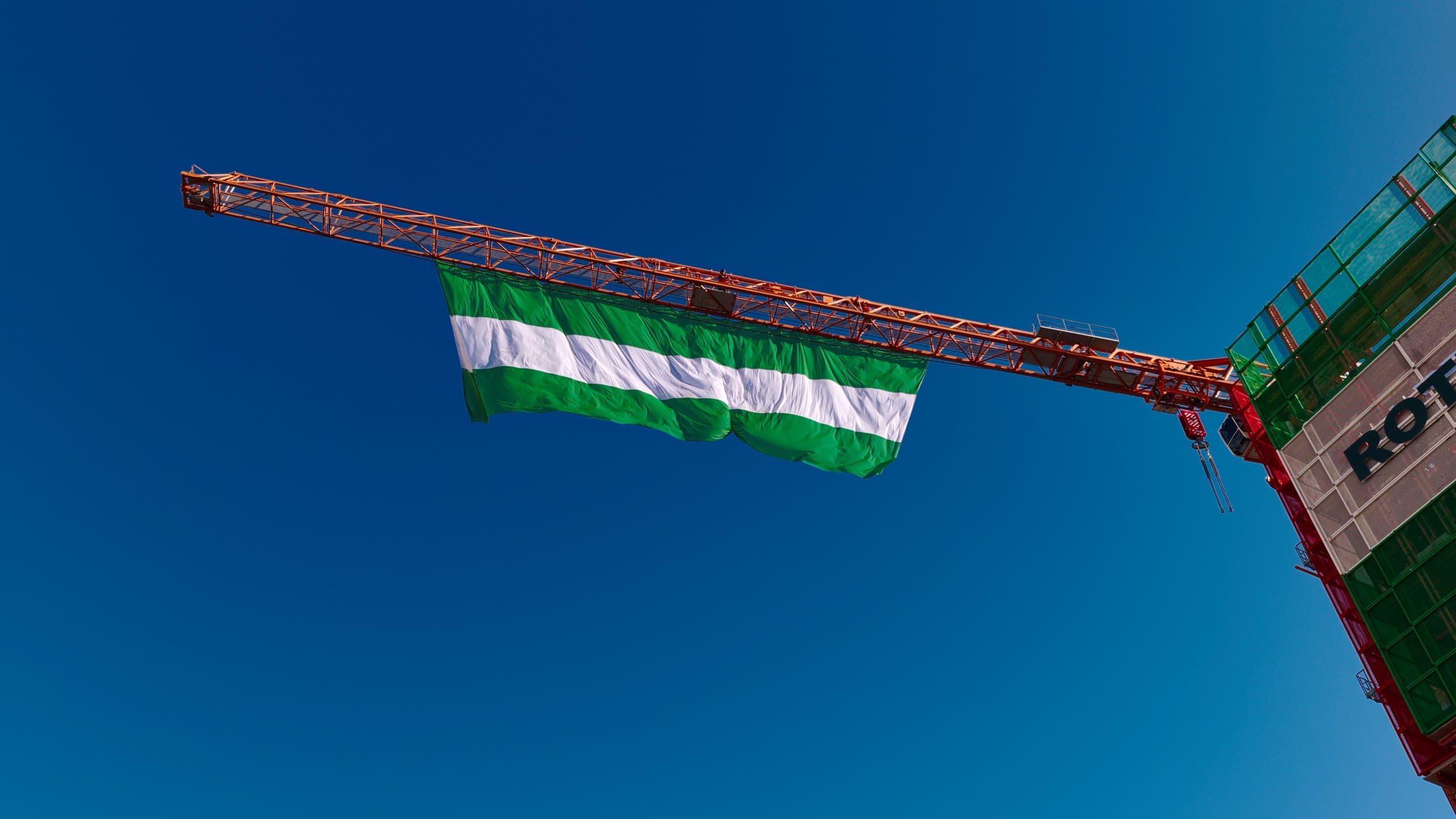 The Rotterdam flag flies from the tower crane at the highest point of The BaanTower